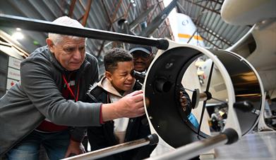 A child looking into a telescope at RAF Midlands