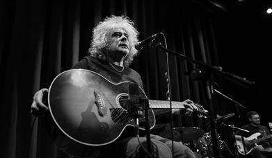 Matt Deighton sat with his guitar
