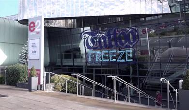 The Telford International Centre exterior with the Tattoo freeze logo on the glass front.