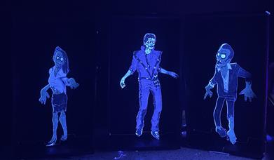 Three creepy mechanical toys that are glowing in the dark