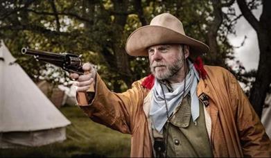 A wild west gun shooter pictured in full costume