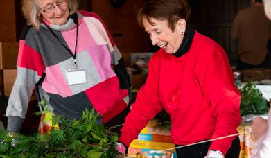 Wreath making workshop, two ladies are making their Christmas wreath.