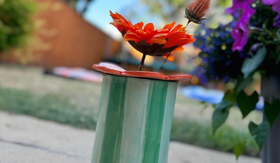 Hand-buillt and decorate a ceramic vase and flower frog
