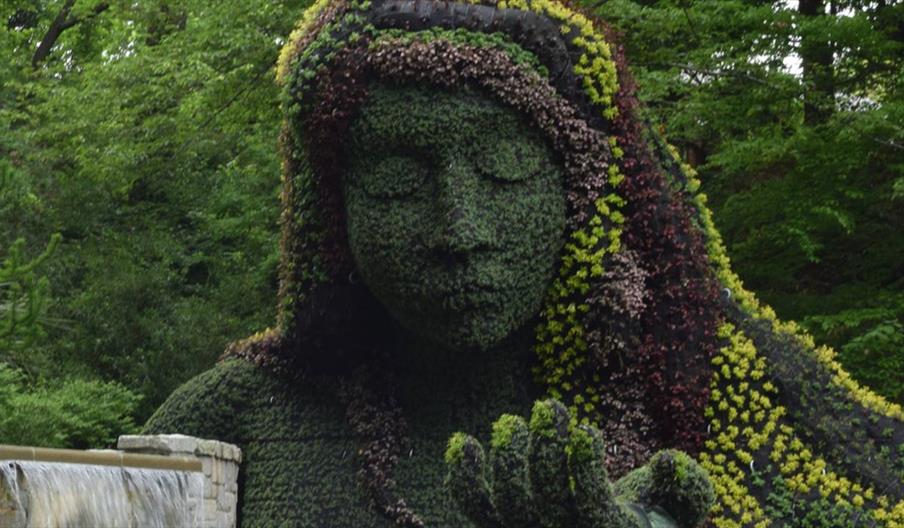 A woman made of green plants