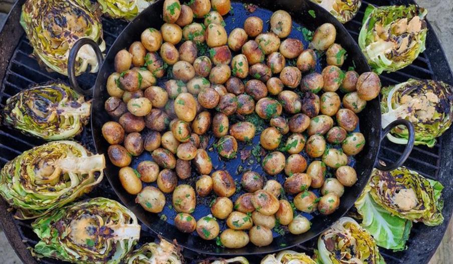 Vegetables cooking on an open grill