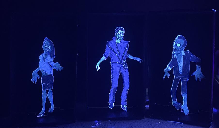 Three creepy mechanical toys that are glowing in the dark