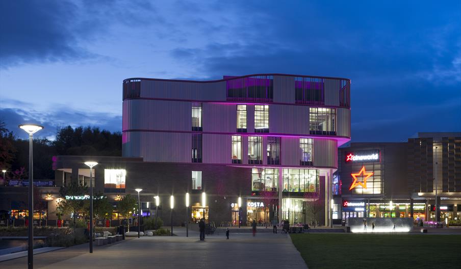 Exterior of Southwater Library illuminated in with purple lights