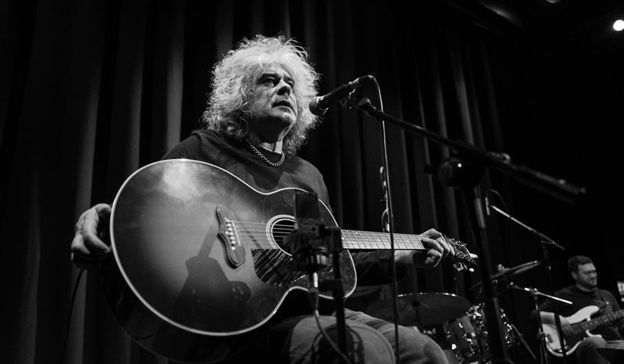 Matt Deighton sat with his guitar