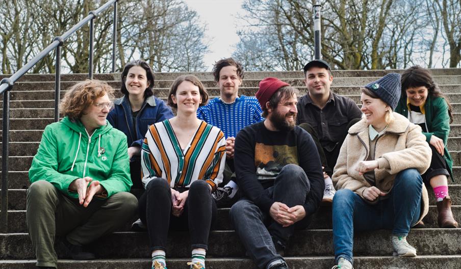 Weird Wave sat on steps together