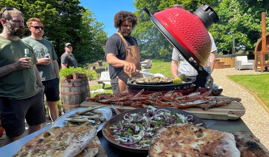 Adam Purnell cooking on open flame