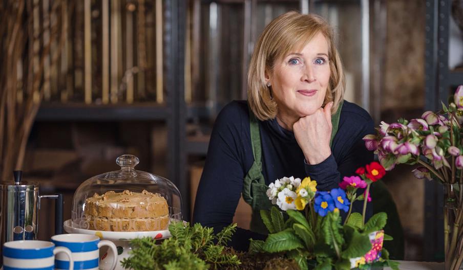 lady with flowers and cake