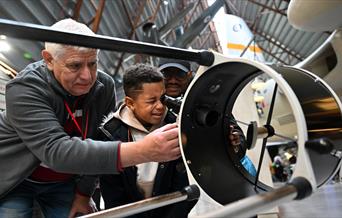 A child looking into a telescope at RAF Midlands