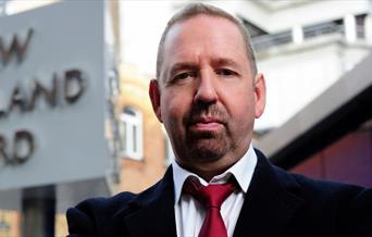 A photo of Alfie Moore outside Scotland Yard