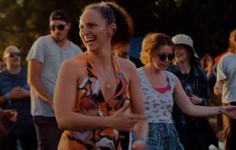 festival goers pictured laughing and enjoying their experience.