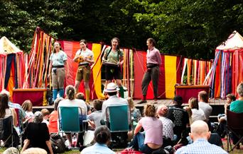 The theatre group pictured performing on an open air stage