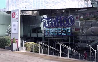 The Telford International Centre exterior with the Tattoo freeze logo on the glass front.
