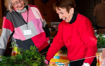 Wreath making workshop, two ladies are making their Christmas wreath.