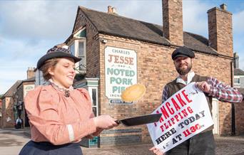 Blists Hill Victorian Town demonstrators flipping a pancake in a frying pan