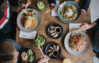 a range of wagamama dishes including donburi, raisukaree, yaki soba and katsu curry. sides include gyoza and edamame beans.