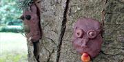 clay faces on trees