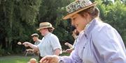 Women in costume compete in egg'n'spoon race at Blists Hill Victorian Town.