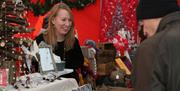 Christmas market stalls pictured with their wares.