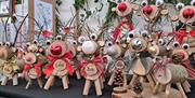 Christmas market stalls pictured with their wares.