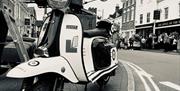 A black and white image of a scooter parked in Bridgnorth