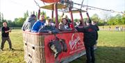 Hot air balloon passengers in hot air balloon basket ready for balloon launch