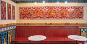 A display of red, blue and yellow tiles set up like a traditional pub.