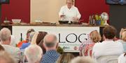 Visitors to Newport Show watch a cooking show