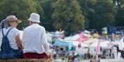 Two adults sat on a hay bale overlooking Newport Show