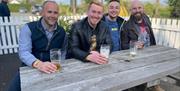 Four men enjoying a pint of beer