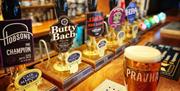 A pint of lager on the bar of a pub