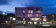 Exterior of Southwater Library illuminated in with purple lights