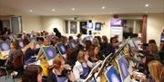 a sip and paint class taking part in an event