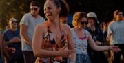 festival goers pictured laughing and enjoying their experience.