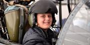 Child sitting inside a Jet Cockpit