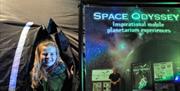 Child stands outside immersive movie tent