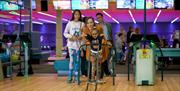 A family playing bowling