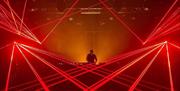 DJ in DJ Booth with red lasers surrounding him