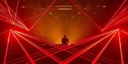 DJ in DJ Booth with red lasers surrounding him