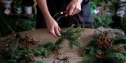 Ladies hands holding a wire floral wreath frame