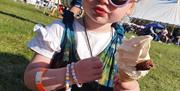 Child holding an ice cream at Water's Edge Festival