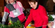 Wreath making workshop, two ladies are making their Christmas wreath.