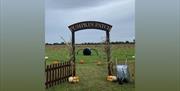 Pumpkin Patch sign and Pumpkins in the field