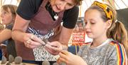 A girl doing some crafts at the Ironbridge WHS Festival