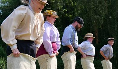 Victorians taking part in a sack race