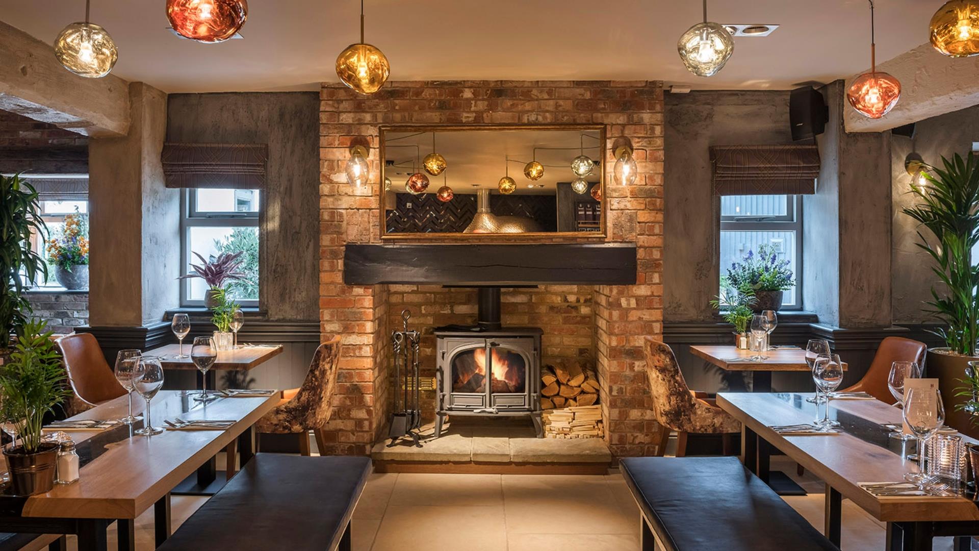 Dining tables and fire place inside a pub in Telford