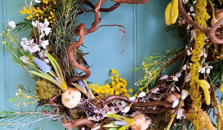 A Spring wreath made with moss, flowers and foulage
